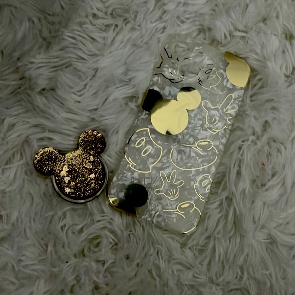 It’s a clear case with gold designs of Mickey Mouse for an iPhone 13